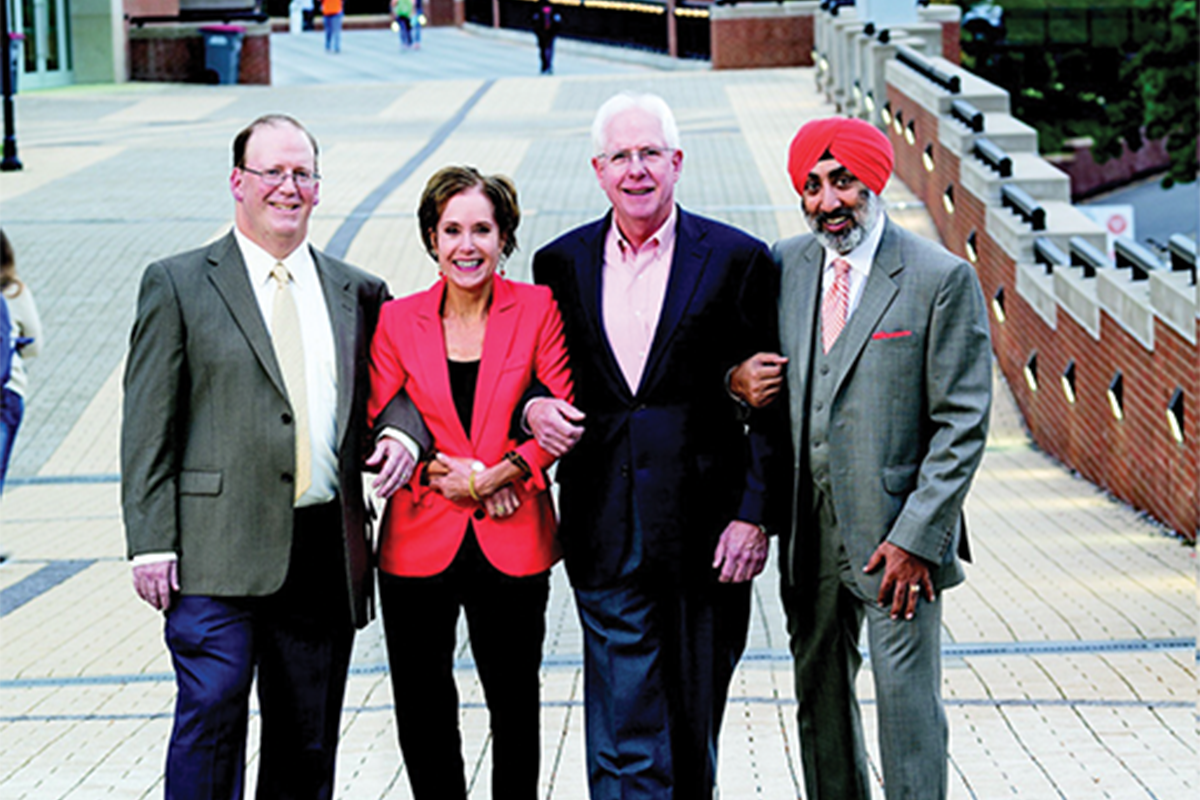 Rupy poses on the University of Tennessee's bridge with colleagues