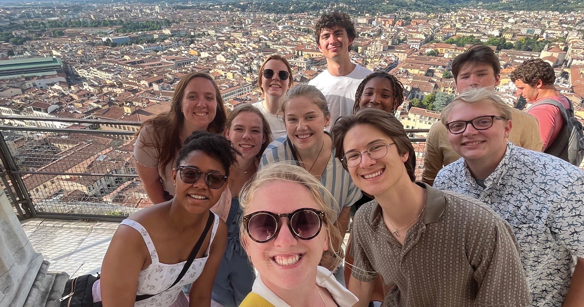 Laura Knight takes a selfie with study abroad students in Italy