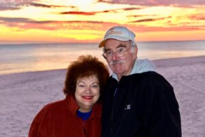 William Sullivan and his wife Janet standing on the beach at sunset
